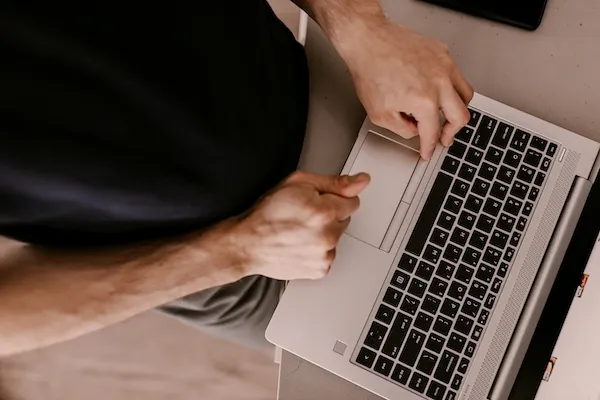 Top down perspective of a man using a laptop