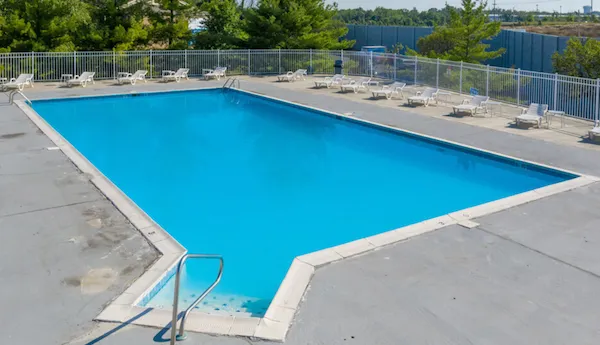Large pool with lounge chairs on a sunny day
