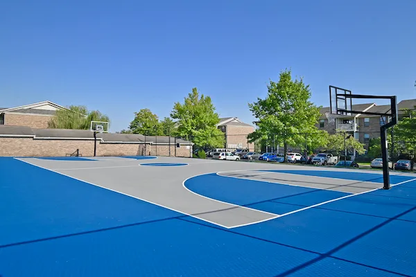 Blue and gray basketball court at Woodspring Apartments