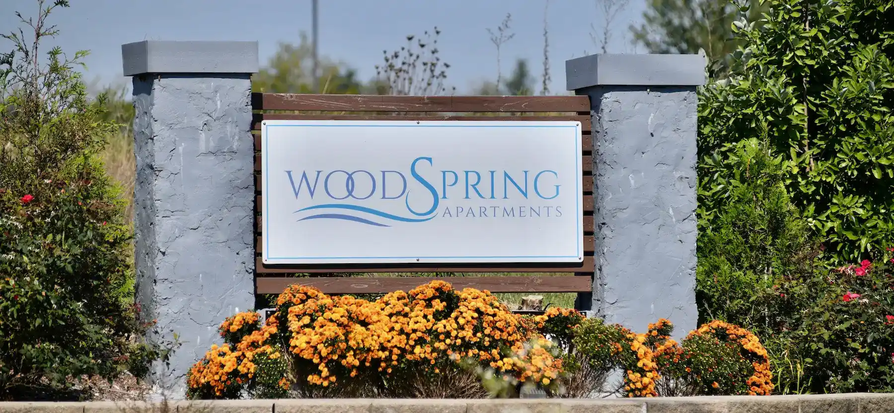 Main entrance sign of Woodspring Apartments