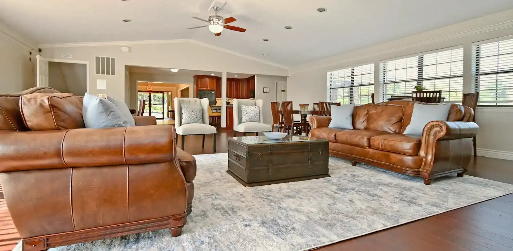 Resident clubhouse with sofas, kitchenette, and group seating
