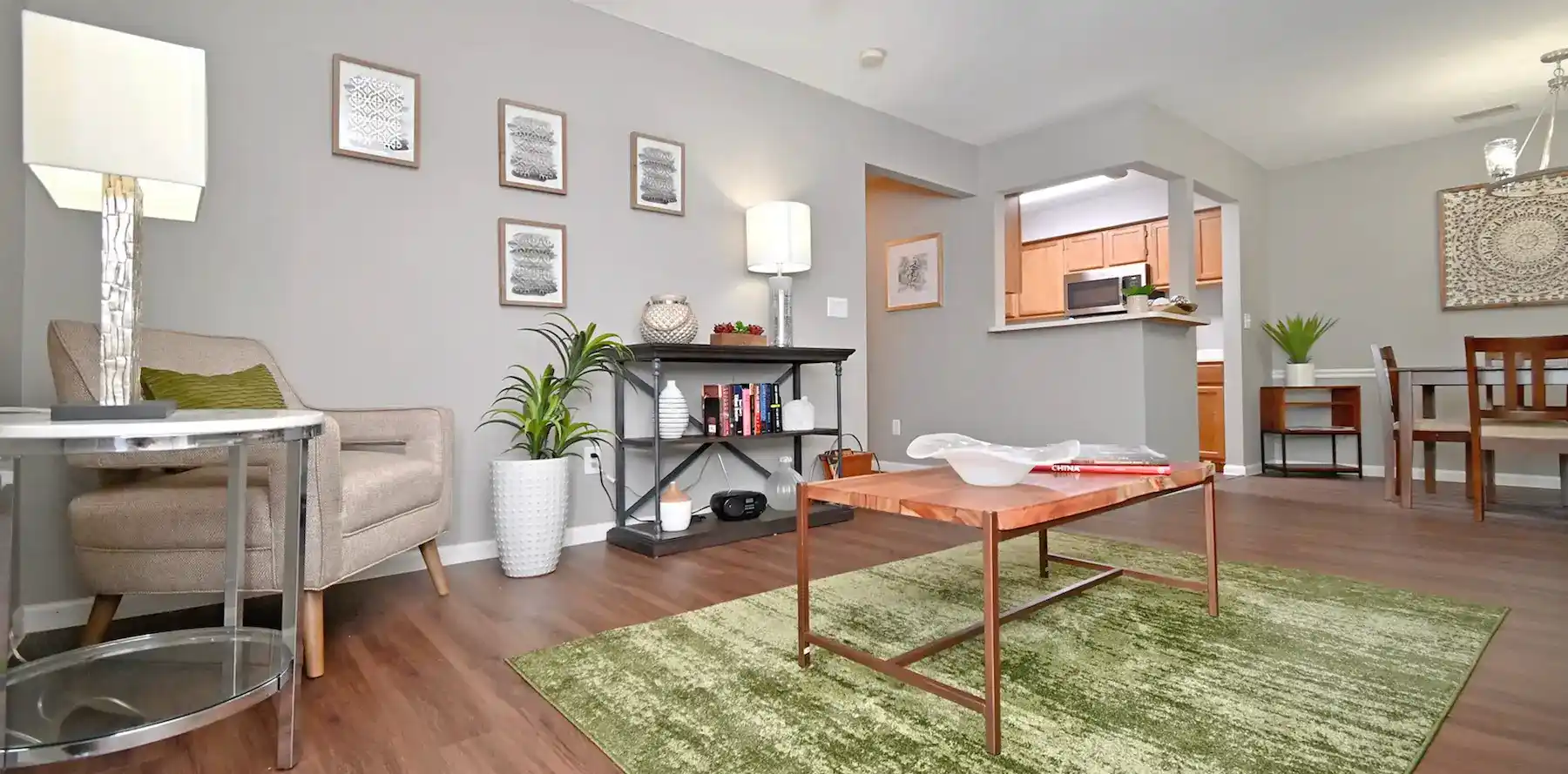 Spacious living room, kitchen, and dining area in Woodspring Apartments