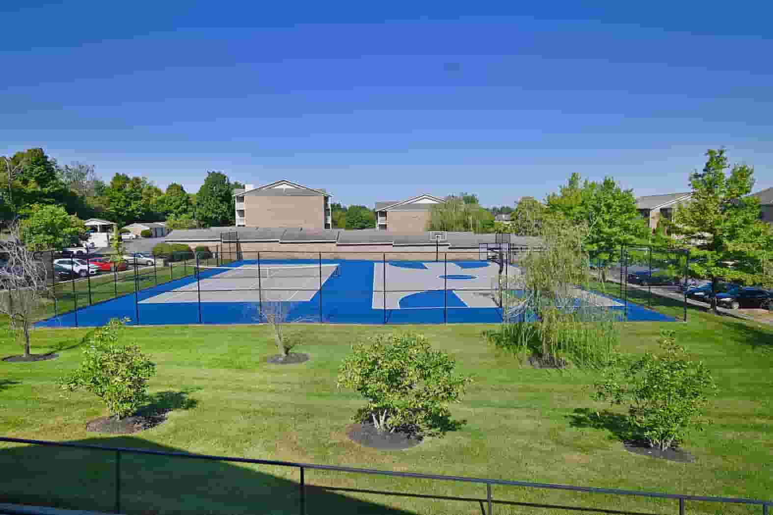 Outdoor tennis and basketball courts on a clear-skied day