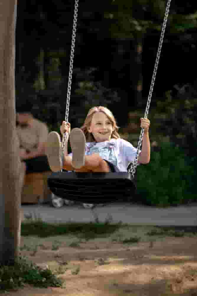 Child playing on swingset